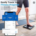 person using a smart Bluetooth body fat scale to track fitness progress on a smartphone app showing body composition data